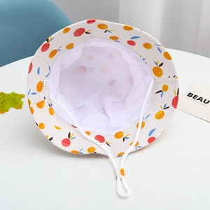 Detail of cotton kids sun hat with fruit print, adjustable chin strap, and size 52 label