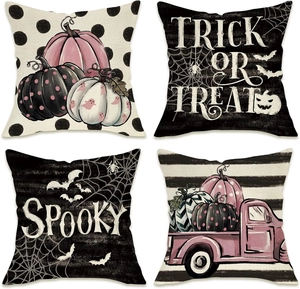 Detail of four Halloween linen pillowcases featuring pumpkins, bats and spiders