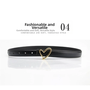 Detail view of women's black leather belt featuring a golden heart-shaped metal buckle