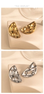 Detail of semi-circle earrings in gold and silver with hammer-textured metal finish