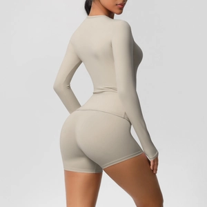 Detail of greige brushed yoga set featuring slim-fit long sleeves and high-rise shorts