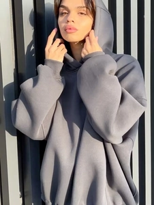 Close-up of oversized dark grey hoodie featuring back letter embroidery and heavy cotton