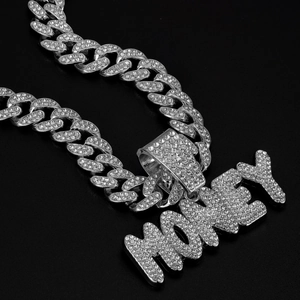 Macro shot of silver iced out Cuban chain necklace with sparkling MONEY letter pendant