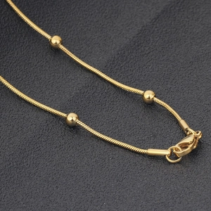 Golden stainless steel snake bone chain necklace with small round beads and lobster clasp