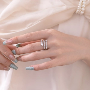 Close-up of multi-layer silver ring with pear and rectangular zircons on model hand