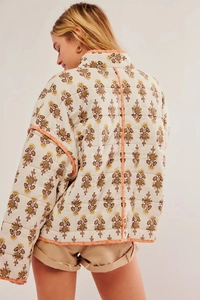 Rear view of quilted cotton jacket with ethnic floral print and orange contrast trim