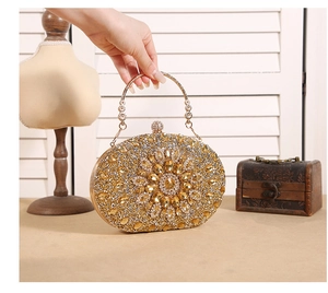 Detailed view of luxury gold sunflower evening bag with radiant crystals and metal handle