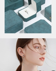 Deep green PU leather jewelry box shown with long silver tassel rhinestone earrings