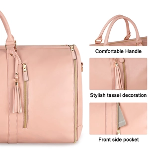 Close-up of pink PU leather travel bag showing comfortable handles and stylish tassel detail