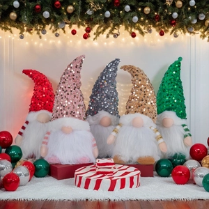 Set of five plush Christmas gnomes with sequins and warm lights on a soft white carpet