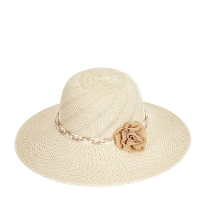 Close-up of beige wide-brim straw hat with elegant floral fabric decor and woven band