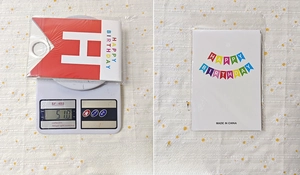 Macro shot of colorful birthday banner on electronic scale weighing 51g in package