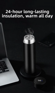 Smart thermos cup with digital temperature display showing 56 degrees on a desk