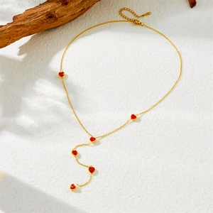 Golden stainless steel Y-shaped necklace featuring six red faceted heart-shaped stones