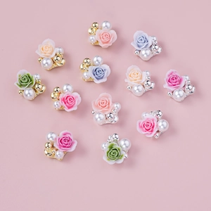 Mix of 3D resin rose charms with pearls and gold beads for floral nail art design