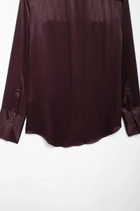 Back view of deep purple satin shirt showing smooth silk texture and buttoned cuffs