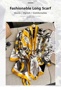 Detail of elegant printed long scarf on sofa with accessories showing soft texture