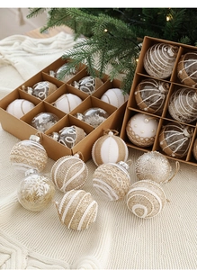 Detailed view of assorted Christmas balls with lace and burlap in a kraft paper box