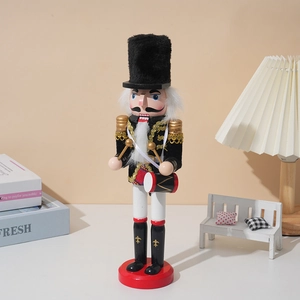 Close-up of wooden Christmas nutcracker soldier drummer on a cozy decorative bookshelf