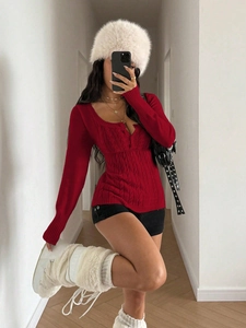 Close-up of red cable knit sweater featuring slim fit design and premium textured fabric