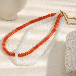 Detail of 18K gold-plated double-layer necklace with orange and white beads