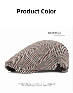 Detail of light khaki plaid flat cap with adjustable leather side strap and brass buckle