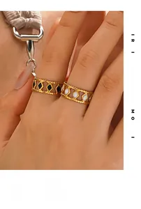 Detail of 18K gold-plated rings with black onyx and white shell diamond-shaped inlays