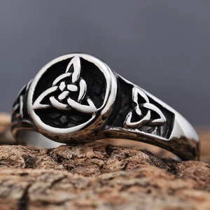 Vintage silver Viking Triquetra ring with oxidized finish on rustic wood background