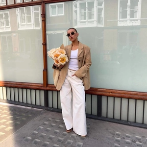 Chic khaki faux suede blazer styled with white wide-leg trousers for a modern autumn look