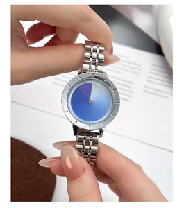 Macro detail of silver steel watch band and blue-purple gradient dial on wrist