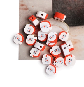 Close-up of red and white Santa Claus polymer clay beads for DIY jewelry making