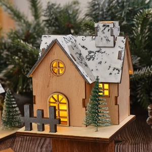 Illuminated wooden Christmas house ornament with snow roof and warm LED lights
