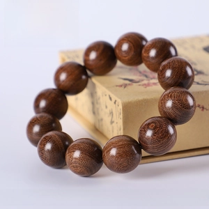 Macro detail of 20mm green sandalwood beads showing high-density grain and polished finish