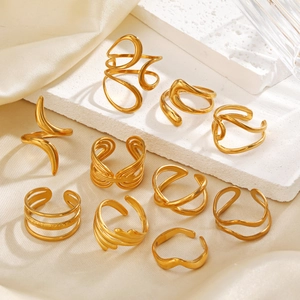 Set of minimalist 18k gold plated stainless steel geometric rings on silk and stone