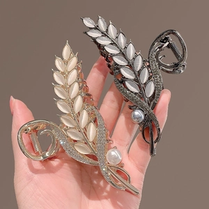 Cat eye stone wheat ear hair claws in gold and gunmetal finish with pearls