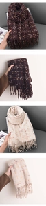 Detail of thick checkered scarves with fringe in dark coffee and cream white colors