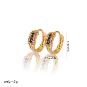 Detail shot of gold hoop earrings featuring black and white zircons and size dimensions
