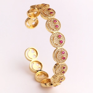Gold-plated smiling face cuff bracelet with red eye gemstones and zircon paving