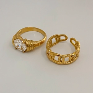Detail of vintage gold plated ring set with oval gemstone and chain link texture