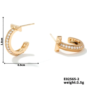 Detail view of gold semi-circle stud earrings with cubic zirconia and dimension labels