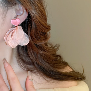 Detail of pink heart earring with layered mesh petals on model for a romantic style