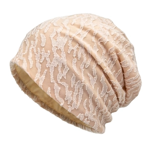 Beige slouchy beanie featuring textured jacquard fabric and smooth silk satin lining