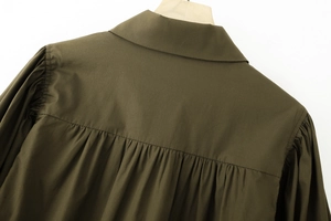 Detail view of the army green cotton shirt back with gathered pleats and yoke stitching