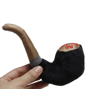 Detail of tobacco pipe-shaped plush dog toy with No Smoking embroidery and woven texture