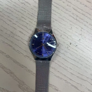 Close-up of WWOOR silver mesh strap watch with blue dial on light wood surface