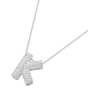 Macro view of iced-out silver letter K pendant with micro-pavé cubic zirconia stones