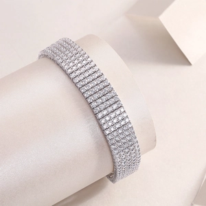 Macro shot of 10-row sparkling crystal tennis bracelet on a white display stand