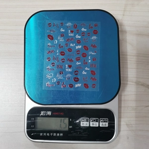Macro view showing 1.5g weight of red lip kiss heart nail stickers for Valentine's decoration