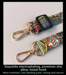 Detail of adjustable crossbody phone strap with vintage totem pattern and gold swivel clip