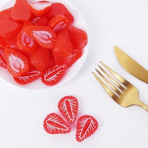 Realistic artificial strawberry models with detailed red texture and sliced fruit halves